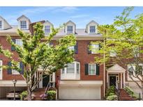 Brick front of charming townhome with lush landscaping and attached garage at 3685 Peachtree Ne Rd # 4, Atlanta, GA 30319