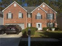Two-story brick home with a two-car garage at 5009 Duval Point Sw Way, Snellville, GA 30039