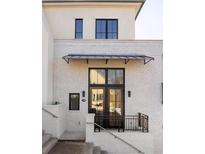 Exterior of a charming townhome with white brick and black windows at 1184 Lupo Loop, Chattahoochee Hills, GA 30268