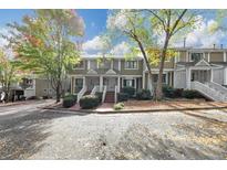 Townhouses with brick front and covered porches at 6 Alston Ne Pl, Atlanta, GA 30324