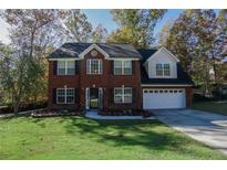 Two story brick home with a welcoming front yard at 981 Wisteria View Se Ct, Dacula, GA 30019