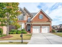 Brick two-story house with three-car garage and landscaped yard at 4689 Prater Se Way, Smyrna, GA 30080