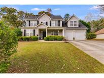 Two story house with attached garage and manicured lawn at 424 Birchwood Dr, Temple, GA 30179