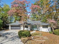 Ranch home with white siding, black garage door, and landscaping at 513 Duke Dr, Marietta, GA 30066