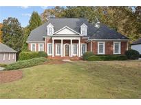 Brick home with a large front yard and a stately portico at 4385 Hamilton Mill Rd, Buford, GA 30518