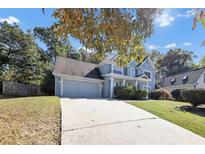 Two-story home with gray siding and a spacious driveway at 214 Kensington Trce, Stockbridge, GA 30281