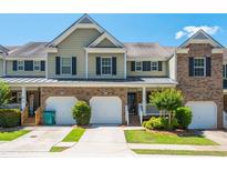 Two-story brick and siding townhouse with two-car garage at 442 Colonial Walk, Woodstock, GA 30189