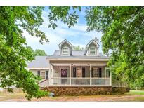 Two story house with front porch and stone base at 160 Cross Rd, Covington, GA 30016