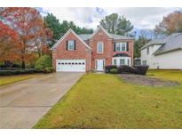 Brick house with two-car garage and landscaped yard at 1457 Brentwood Dr, Marietta, GA 30062