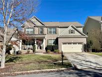Brick two-story house with a two-car garage and manicured lawn at 1428 Sparkling Cove Dr, Buford, GA 30518