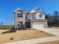 Two-story brick home with a large front yard and attached two-car garage at 452 Eagles Nest Cir, Auburn, GA 30011