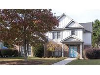 Two-story house with brick and siding, featuring a light blue door and landscaped yard at 340 Bay Grove Rd, Loganville, GA 30052