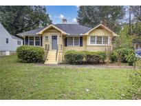 Charming yellow brick ranch house with well-manicured lawn at 1778 Campbellton Sw Rd, Atlanta, GA 30311