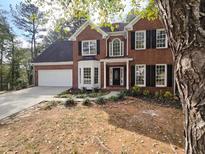 Brick two-story house with a large front yard and landscaping at 2654 Calumet Farm Ln, Snellville, GA 30039
