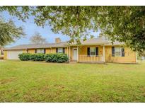 Ranch style home with attached garage and landscaped yard at 1187 Dixie Rd, Covington, GA 30014