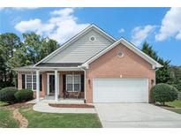 Brick ranch house with attached garage and landscaping at 803 Cork Oak Ln, Lawrenceville, GA 30045