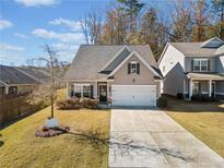 Attractive Craftsman style home with a two-car garage and well-manicured lawn at 117 Prescott Dr, Canton, GA 30114