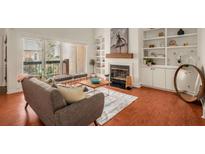 Living room features a fireplace, built-in shelving, and hardwood floors at 5356 Brooke Ridge Dr, Dunwoody, GA 30338