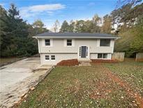 Two story house with gray siding and a manicured lawn at 5876 Poplin Ct, Lithonia, GA 30058