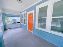 Inviting front porch with bright orange door at 535 Lake Dr, Hapeville, GA 30354