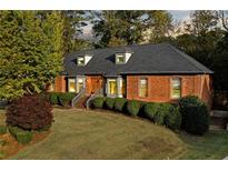 Brick home with gray roof, landscaping, and a walkway leading to the entrance at 2545 Winthrope Way, Lawrenceville, GA 30044