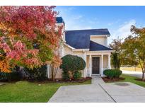 Tan siding house with dark door, walkway, and landscaping; autumn leaves at 6315 Wellington Walk Way, Lithonia, GA 30058