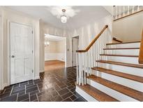 Bright entryway with tile floor, coat closet, and staircase at 3178 Hathaway Ct, Atlanta, GA 30341