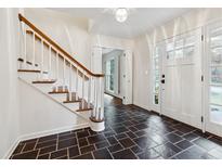 Bright entryway with tile flooring, wooden staircase, and views to additional rooms at 3178 Hathaway Ct, Atlanta, GA 30341