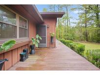 Home's exterior showcasing a deck and landscaping at 10 Gentry Dr, Mcdonough, GA 30252