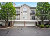 Three-story building with attached garages and landscaping at 4248 River Green Nw Dr # 310, Atlanta, GA 30327