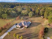 Aerial view of home on large lot with mature trees at 620 Springview Dr, Covington, GA 30014
