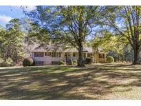 Brick ranch house with large yard and mature trees at 3520 Tom Brewer Rd, Loganville, GA 30052