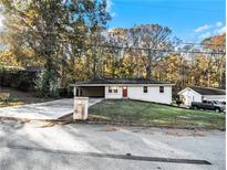 Ranch style home with carport, and a spacious yard at 3811 Paul St, Douglasville, GA 30135