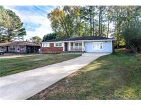 Ranch style home with brick facade and carport at 1396 Gale Dr, Norcross, GA 30093