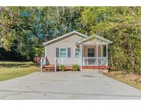 Charming one-story house with a covered porch and spacious driveway at 3464 Linecrest Rd, Ellenwood, GA 30294