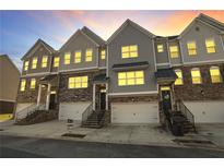 Three-story townhouses with attached garages and stairs at 4262 Buford Valley Way, Buford, GA 30518