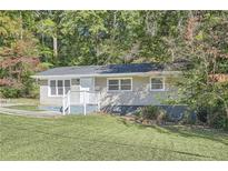 Ranch house with light brick exterior and small yard at 3459 Adkins Nw Rd, Atlanta, GA 30331