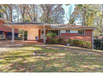 Brick ranch house with carport and mature trees at 2715 Connally Sw Dr, Atlanta, GA 30311