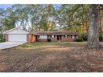 Brick ranch house with attached garage and large yard at 2273 Hampton Locust Grove Rd, Locust Grove, GA 30248