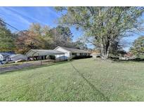 Ranch home with carport and a well-maintained yard at 3081 Frankie Ln, Duluth, GA 30096