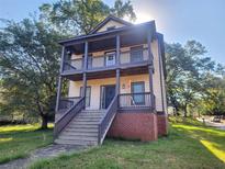 Two-story house with front porch and steps, brick base, and well-maintained lawn at 1812 Lakewood Se Ave, Atlanta, GA 30315
