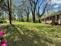Brick ranch home with a spacious front yard and mature trees at 2962 Mcafee Rd, Decatur, GA 30032