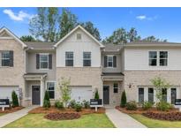 Two-story townhouses with brick and siding at 439 Payne Dr, Mcdonough, GA 30253