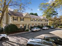 Tan multi-unit building with ample parking and landscaping at 6900 Roswell Rd # D5, Atlanta, GA 30328