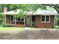 Brick ranch house with a spacious yard and mature trees at 5621 Zanola Sw Dr, Mableton, GA 30126
