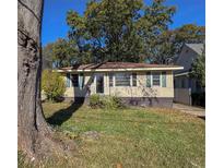 Ranch home with mature trees and a well-maintained lawn at 1511 Walker Ave, College Park, GA 30337