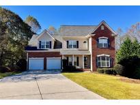 Two-story brick home with three-car garage and landscaped lawn at 138 Slippery Rock Ct, Villa Rica, GA 30180