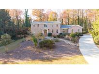 Brick house with landscaped yard and long driveway at 2237 Gunstock Dr, Stone Mountain, GA 30087