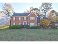 Two-story brick home with a manicured lawn at 2210 Surrey Trl, Atlanta, GA 30349