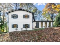 Renovated two-story house with gray shutters and a landscaped yard at 1433 Mary Dale Dr, Lilburn, GA 30047